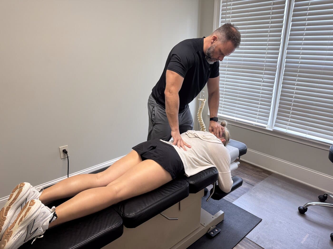 Dr. Joseph Krzemien treating an athlete in the clinic