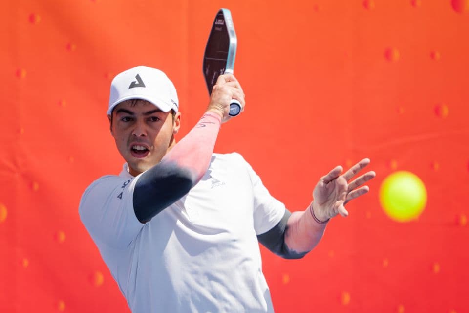 A pickleball player moving through a training point
